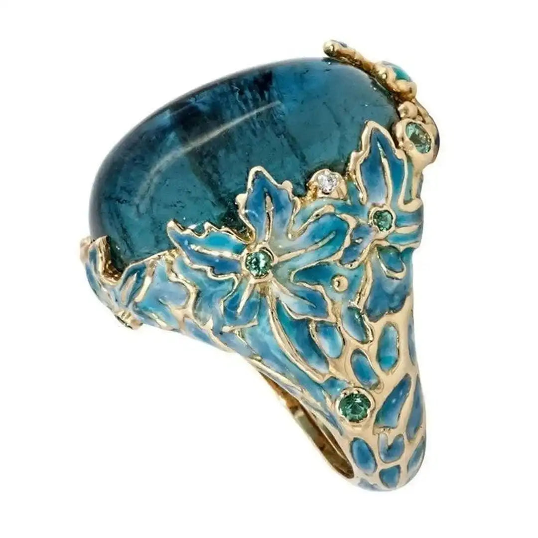 Inel elegant floare de culoare aurie cu piatră albastră